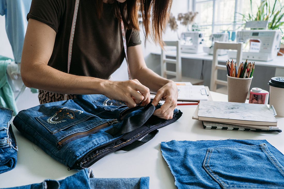 Woman upcycling denim clothes