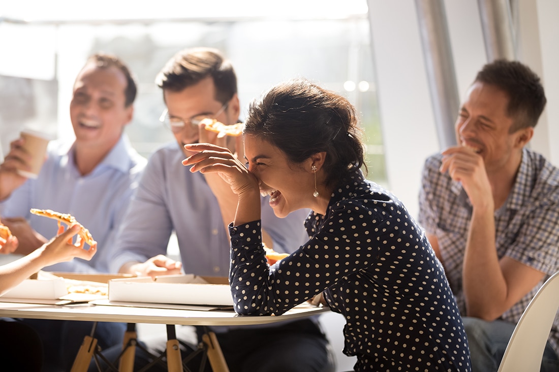 Coworkers laughing at conference table