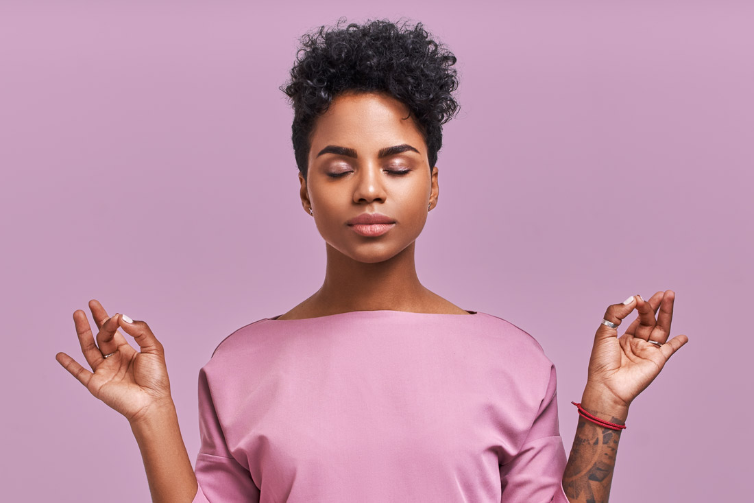 calm meditating women exemplifying self-improvement hacks
