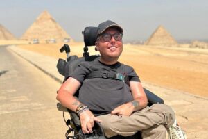Cory Lee poses in front of the pyramids in Egypt