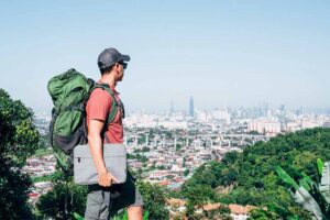 confident backpacker exemplifying digital nomad health insurance