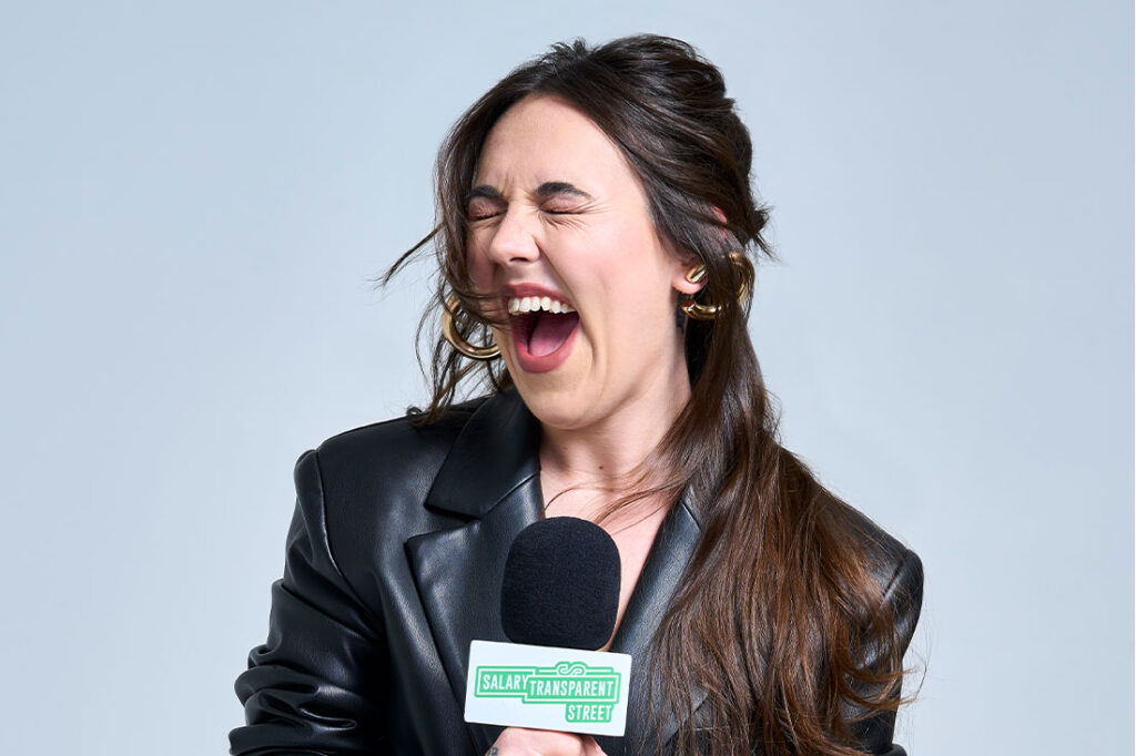 hannah williams screaming into a microphone with gray backdrop