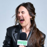 hannah williams screaming into a microphone with gray backdrop