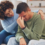 Woman hugging a sad man