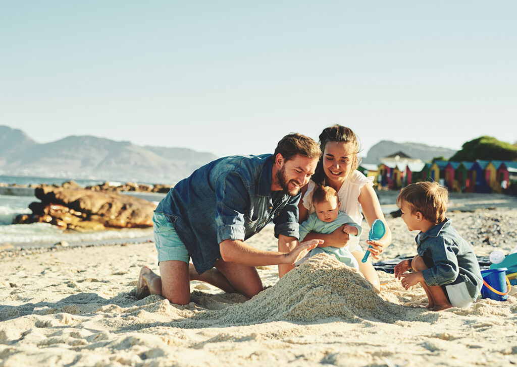 Family with child and baby on the beach