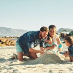 Family with child and baby on the beach