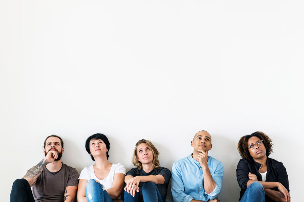 A diverse group of workers contemplating the dilemma of unlimited pto