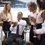 Coworkers celebrating gift giving in the workplace