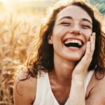 a woman smiling in a field