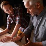 Father and son discussing leadership transitions in family-owned businesses