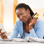 happy women using the ynab app on her phone