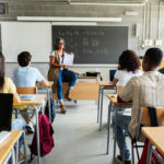Teacher with group of students in a classroom