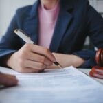 A woman signs a contract.