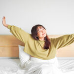 young women waking up in the morning with a smile