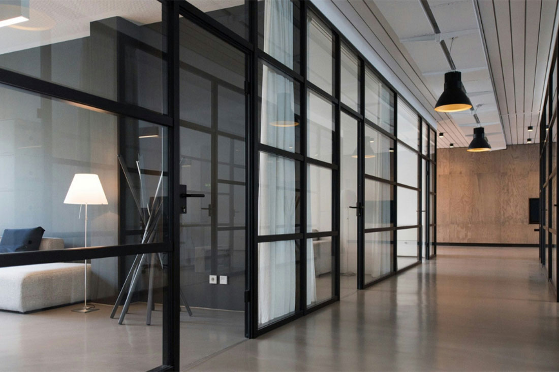 interior of modern office with hallway and room with couch