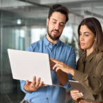 Two coworkers exemplifying adaptability as they discuss changing business plans