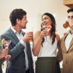 Coworkers enjoy drinks at a happy hour work event