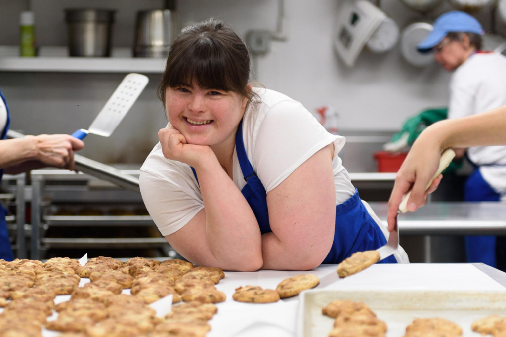 Entrepreneur Collette Divitto in a kitchen surrounded by cookies