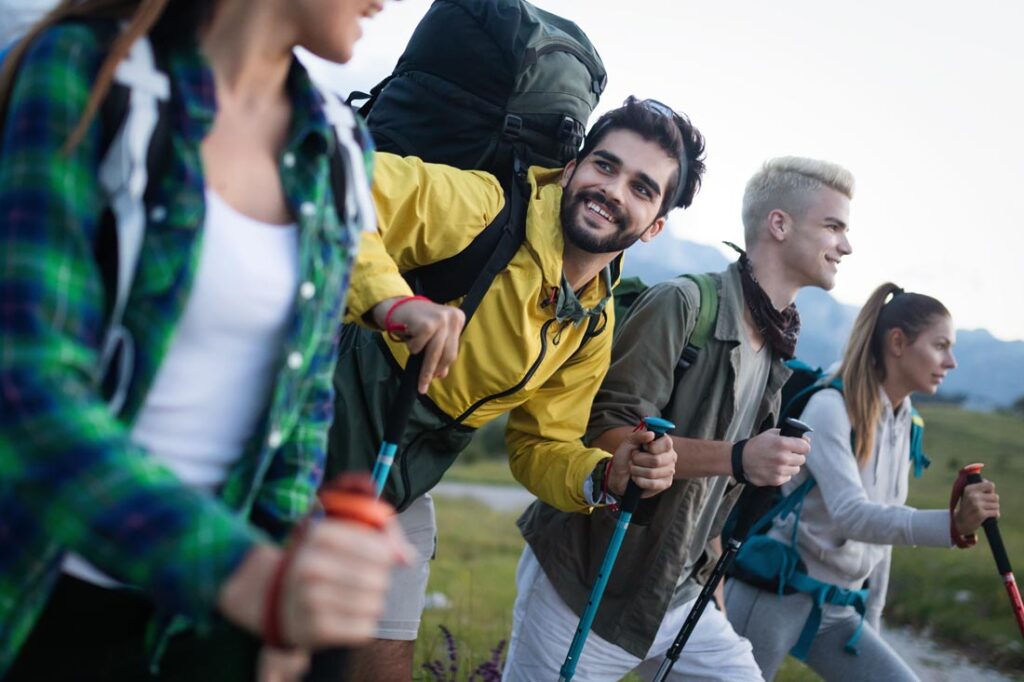 Four strangers hiking together and smiling