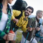 Four strangers hiking together and smiling