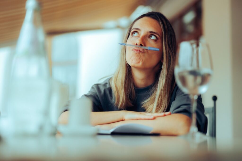 A woman balances a pen on her upper lip.
