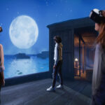 Three individuals experience a virtual landscape in a virtual reality expedition