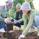 Group of people planting trees giving back to the community