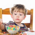 Young boy eating breakfast cereal