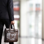Businessman holding a briefcase in a modern office