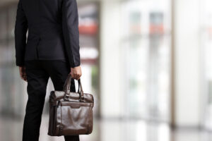 Businessman holding a briefcase in a modern office