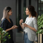 two businesswoman discussing at workplace