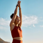 a woman doing a yoga pose outside