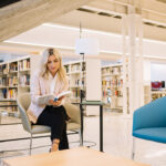 A woman reads a book on leadership