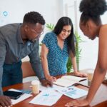 Three professionals doing market research for small business