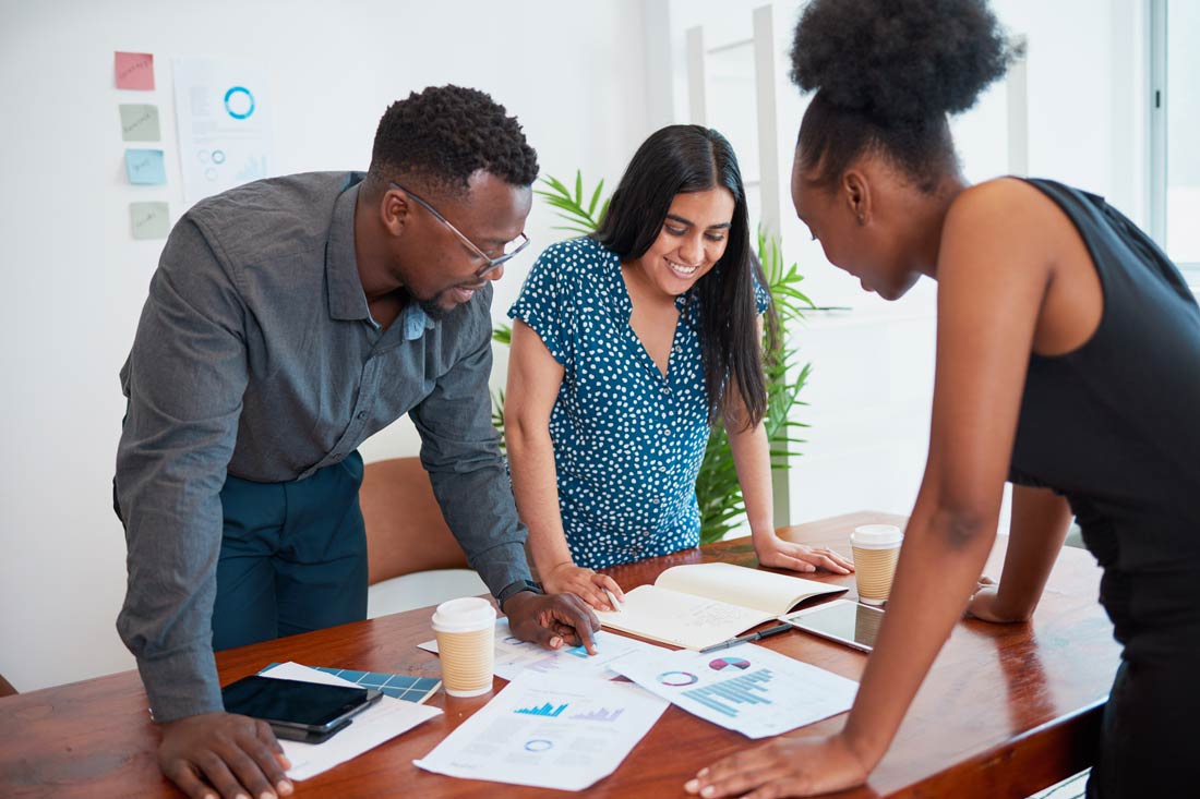 Three professionals doing market research for small business