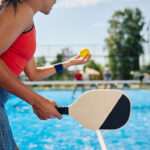 Woman networks with coworkers while playing pickleball