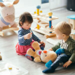 cute little girl and boy playing with toys