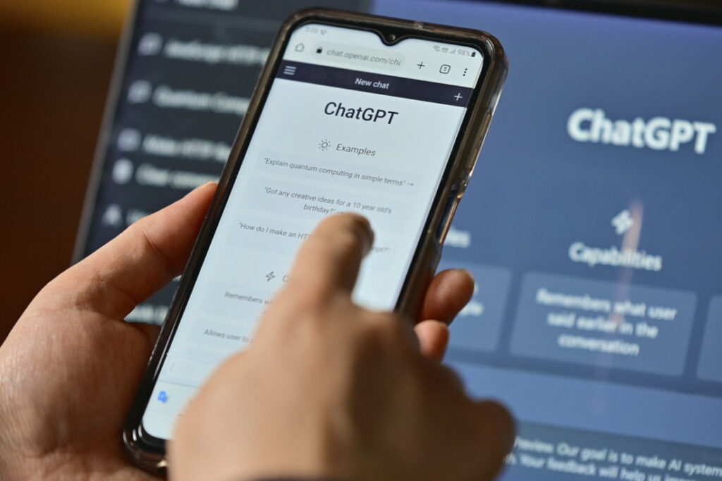 person using ChatGPT on their phone and computer