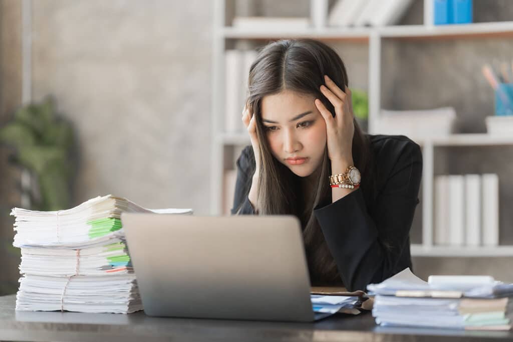 woman hard working overwhelmed by procrastination