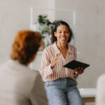 Smiling leader talking to her collogues