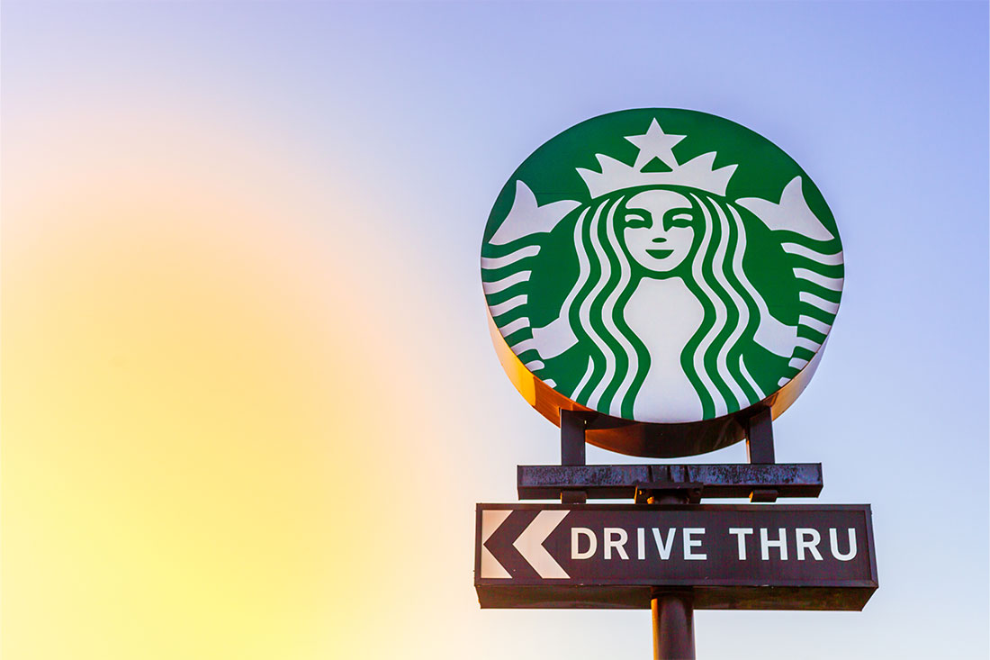 Starbucks drive thru sign against evening sky