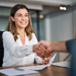a hiring manager shaking a future employees' hand
