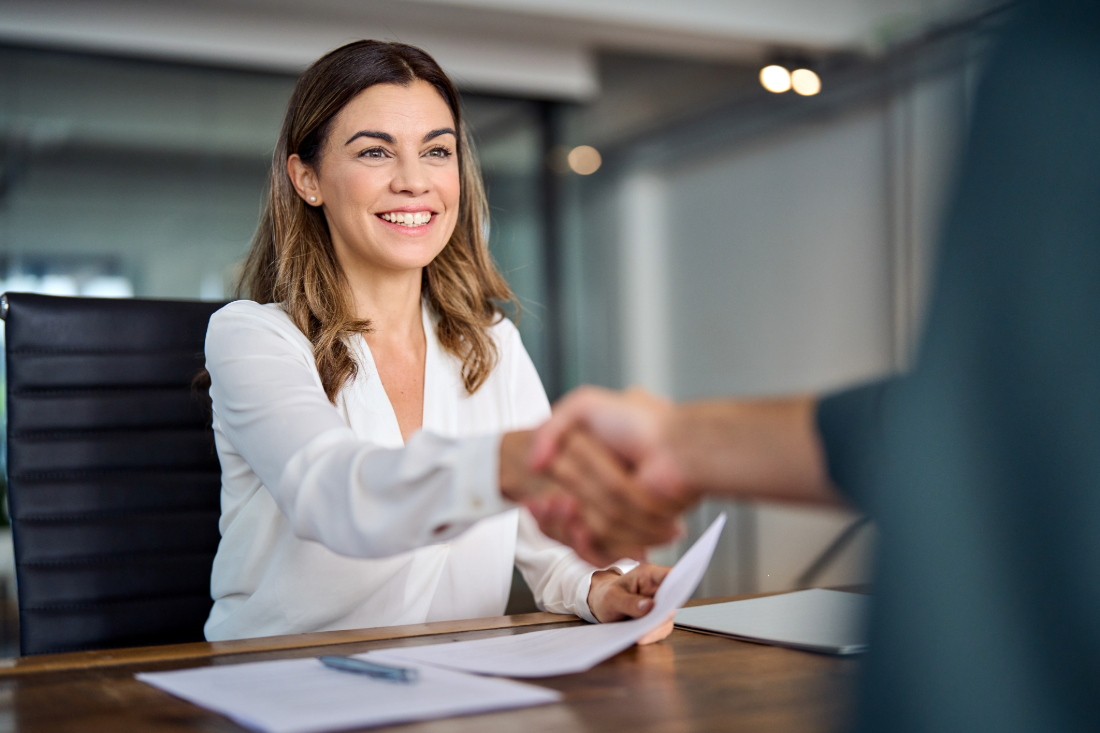 a hiring manager shaking a future employees' hand