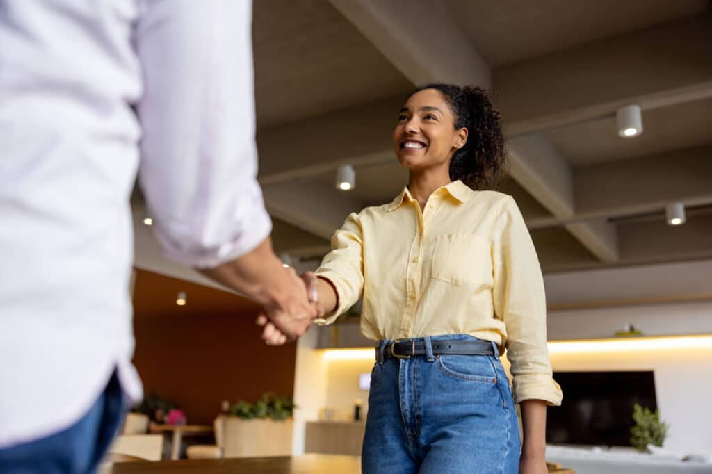Woman shaking hands at job interview