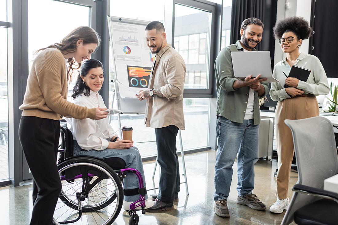 Diversity and inclusion in the workplace as a diverse group of coworkers work on a project together