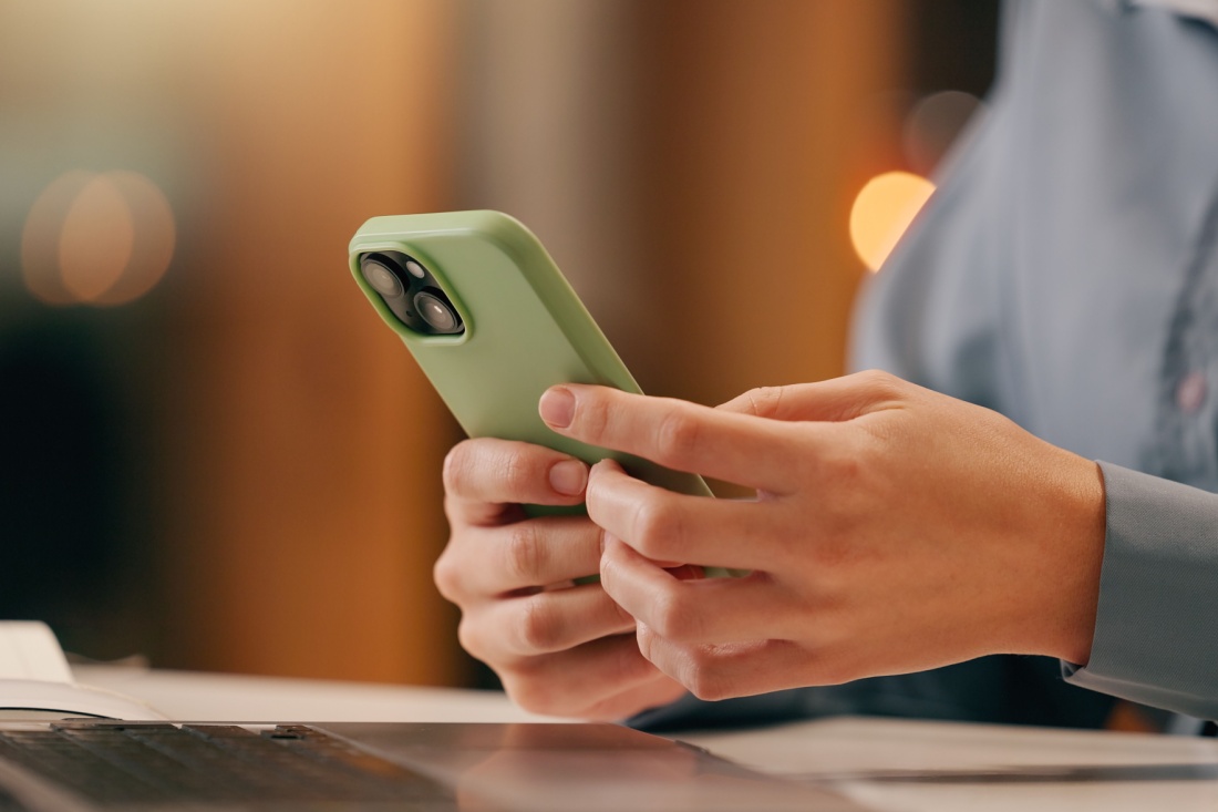 Close up on a hand holding a smartphone.