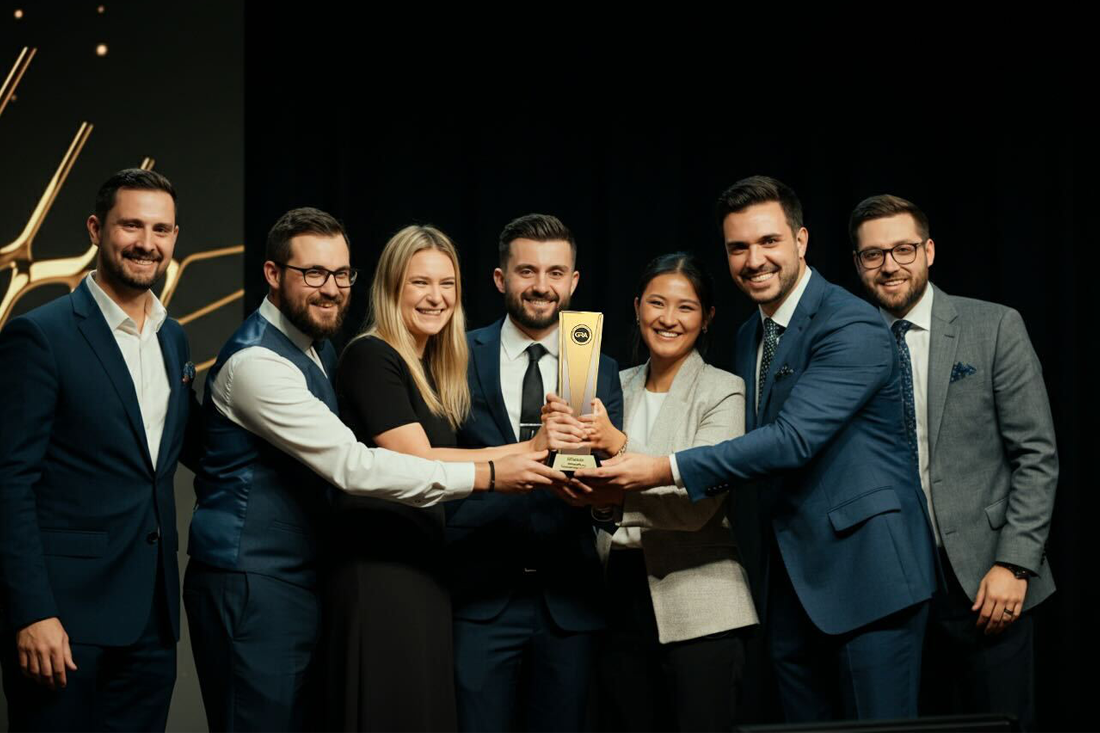 A group of people accepting an award.