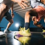 Two male athletes play basketball while wearing Xero Shoes