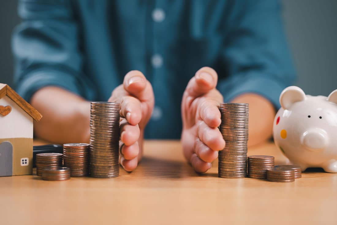 Hands separate coins on table