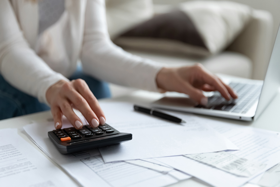 A woman calculates earnings from the best business to start with little money